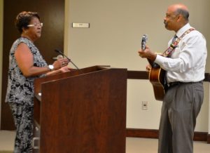 Department of Aging Director Sandra Murphy (left) introduces guitar-wielding Chester County Commissioners' Chairman Terence Farrell. 
