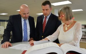 Chester County District Attorney Tom Hogan (from left) examines real-estate documents with Recorder of Deeds Rick Loughery and Ruth Huganir, a deputy recorder.