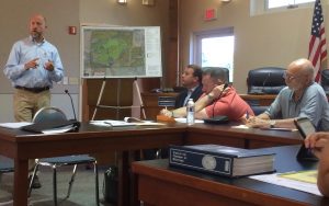 Andrew J. Semon (left), division president for Toll Brothers, discusses plans for Crebilly Farm as Gregg I. Edelman, a Toll Brothers attorney, and Westtown Township Supervisors Thomas F. Haws and Mike T. Di Domenico listen.