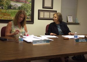 Supervisors Elaine DiMonte and Ricki Stumpo review documents at Monday night's meeting. Supervisor Alice Balsama was out of town and did not attend.
