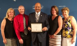  Chester County Commissioners’ Chairman Terence Farrell holds the National Association of Counties (NACo) Achievement Award for Employment and Training. He is joined by CCIU representatives Jacalyn Auris (from left), Scot Semple, Laurie Masino and Anita Riccio. 