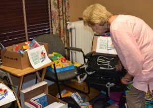 Peggy Gusz, executive director of the Crime Victims Center, surveys the school supplies destined for child crime victims.