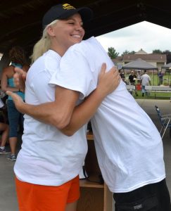 Avondale Trooper Samantha Minnucci, who conceived and implemented Sunny Day Camp, gets a hug from her brother Gabriel, who provided her motivation.