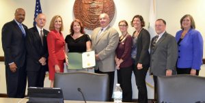 Denise Graf (holding citation) is joined by the Chester County Commissioners and members of the county's Department of Emergency Services.