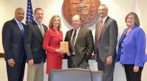 Chester County Commissioner Michelle Kichline shows off the county's sustainability award along with her fellow commissioners and members of the county's Planning Commission.