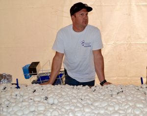 Brent Stinson, a third generation mushroom grower, fields questions in the industry tent.