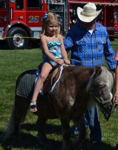 Four-year-old Addy Twesten enjoys a pony ride.