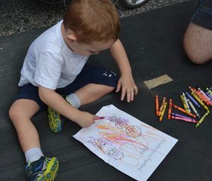 Two-year-old Luca Motoc of Wilmington enjoys the coloring opportunities the Mushroom Festival provided.