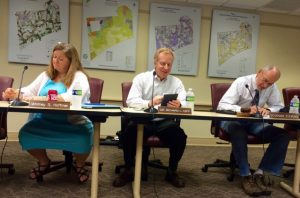 Kennett Township Supervisors Whitney S. Hoffman (from left), Richard L. Leff, and Scudder G. Stevens, check their notes prior to the start of their Sept. 21 meeting. 