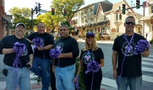 Volunteers from Fox & Roach Charities deck out downtown Kennett Square with purple ribbons.