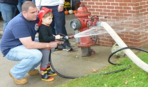 Longwood Fire Company Chief A. J. MaCarthy gives instructions to his son Jeremy during the open house celebration. 