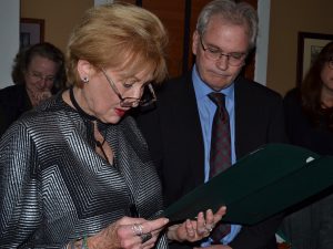 Peggy Gusz, executive director of the Crime Victims' Center, reads a proclamation from the Chester County commissioners as Chester County Court Judge Patrick C. Carmody looks on. 
