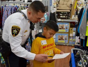 Capt. Jason Syudan helps a shopper with his list.