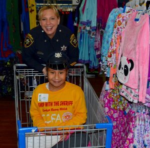 Deputy Sheriff Teresa Miller navigates the pajama department with one of her shoppers.