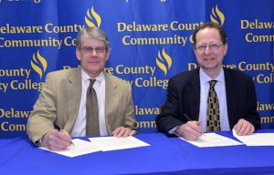 Delaware County Community College President Dr. Jerry Parker and Pennsylvania Academy of the Fine Arts President/CEO Dr. David Brigham sign transfer agreement.
