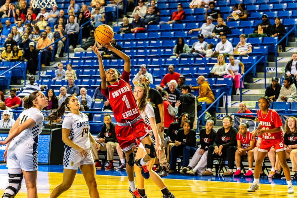 Smyrna senior Amiyah Ellerbe finishes at the basket against Sanford in the semifinals. Photo Credit Dave Reeder.