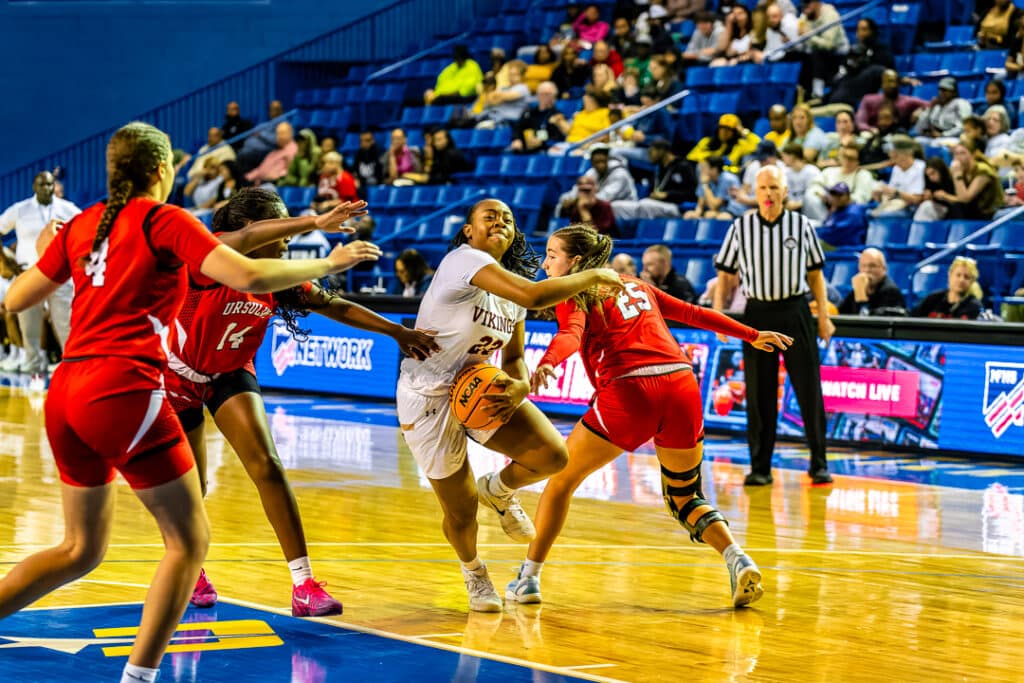 St. Elizabeth freshman Taylor Tucker drives through traffic in the second semifinal game Tuesday night. Photo Credit Dave Reeder.